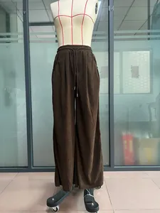 Full view of high waist brown corduroy wide-leg drawstring trousers on mannequin