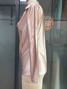 Macro side view of a champagne satin cowl neck long-sleeve blouse on a mannequin