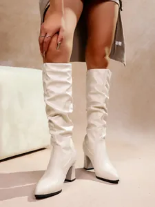 Elegant cream white pointed-toe knee-high boots with a slouchy design and block heel.