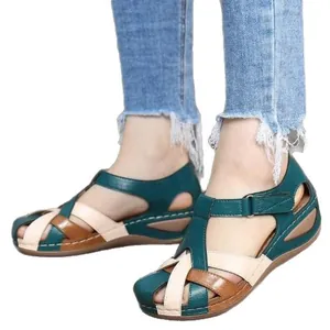 Comfortable women's retro wedge sandals with round toe and cross-strap buckle closure.