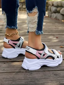 Detailed side view of women's chunky platform sports sandals in silver and pink