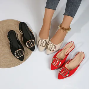 Detailed view of pointed toe flat slingback shoes in black, beige, and red with metal buckles