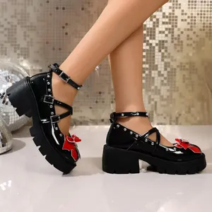 Black patent leather Mary Jane shoes with thick sole and red bow detail in JK style.