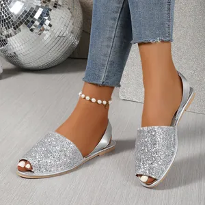 Close-up of sparkly silver sequin flat peep-toe sandals for women's fashion