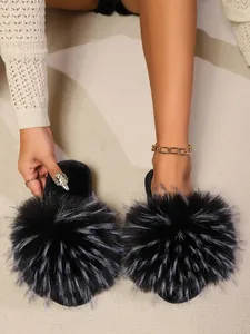 Close-up detail of luxurious black fluffy faux fur slides for stylish women home wear