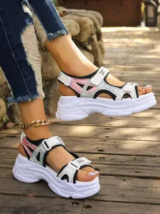 Close-up of women's chunky platform sports sandals with holographic pink accents