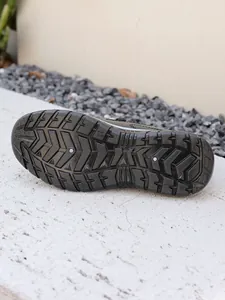 Detail view of the durable black platform outsole with non-slip traction pattern.