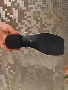 Detail view of the non-slip black sole of a women's sandal with size 36 mark.