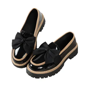 Classic black patent leather platform loafers for women with a stylish oversized bow