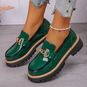 Dark green patent leather platform loafers featuring chunky soles and gold chains