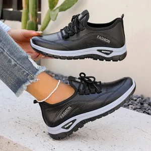 Stylish black women's platform sneakers with lace-up closure for casual comfort
