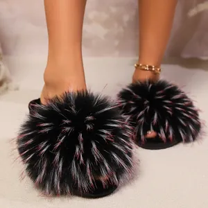Cozy women's black plush slippers featuring oversized fluffy red-tipped poms for winter