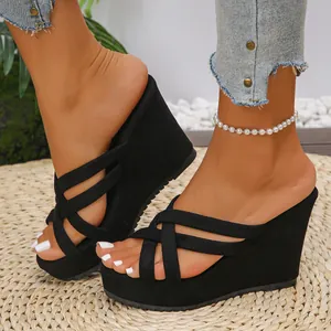 Stylish black suede wedge slippers featuring platform sole and elegant cross straps for women