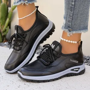 Women's black casual platform sneakers with lace-up design and fashion lettering.