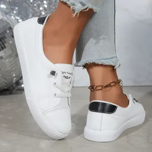 Classic women's white leather sneakers with black trim and low-cut casual board shoe design
