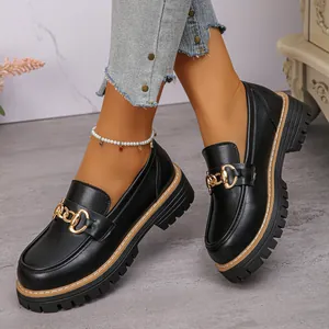 Elegant black leather loafers for women featuring chunky platform soles and gold chain details