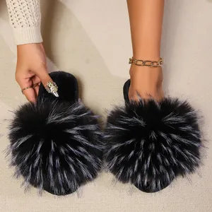 Elegant women's black faux fur slides with fluffy texture shown on a soft carpet.