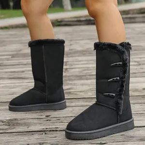 Detailed view of black women's snow boots with side horn buckles and fur lining