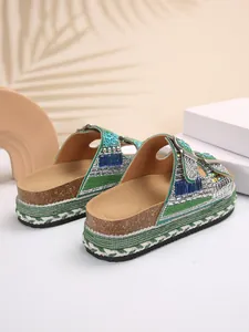Detailed macro shot of rhinestone-embellished thick sole cork beach sandals for women