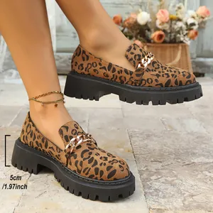 Side view of leopard print loafers showing 5cm chunky heel and chain detail