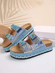 Detailed view of blue rhinestone platform sandals with braided rope and cork sole