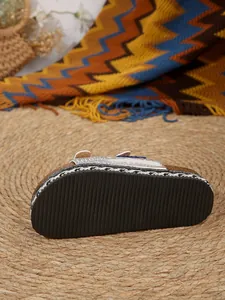 Detail of non-slip rubber sole and rhinestone straps on luxury cork beach sandals.