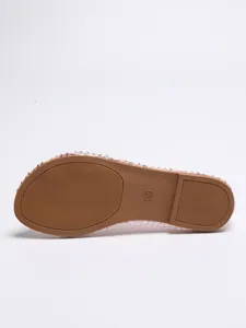 Detailed view of the brown anti-slip textured sole for women's flat fishnet sandals