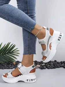 Detailed view of women's white platform sports sandals with rhinestones and magic tape