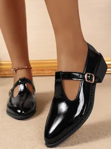 Close-up of elegant black patent leather T-strap Mary Jane shoes with chunky heel
