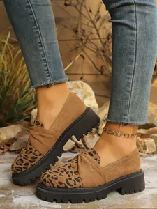 Detailed view of leopard print loafers with thick platform soles and soft suede finish