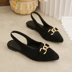 Black suede slingback flat sandals featuring a gold horsebit buckle and pointed toe.
