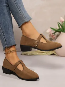 Elegant brown suede chunky heel Mary Jane loafers with buckle strap shown on a model's feet