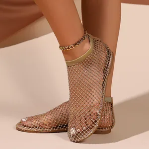 Detailed view of women's sparkling rhinestone fishnet flat sandals with stylish hollow design