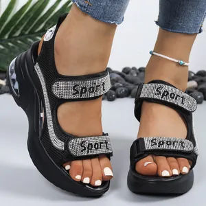 Black platform sandals with sparkling rhinestones and adjustable velcro straps.