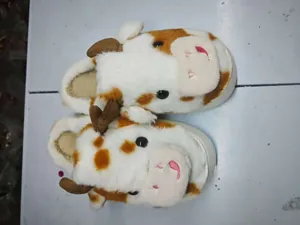 Detail of cute cow pattern plush winter slippers with thick warm lining and non-slip sole
