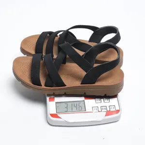Detail shot showing lightweight black elastic strap flat sandals weighing 314.6g on a digital scale