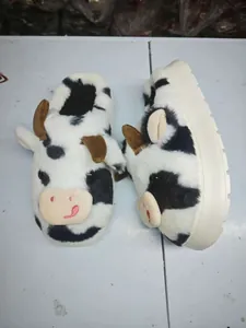 Warm plush cow pattern home slippers featuring thick non-slip sole and cute cartoon design