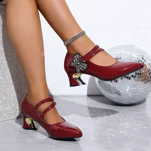 Elegant red patent leather pumps featuring rhinestone butterfly and gold chunky heels.