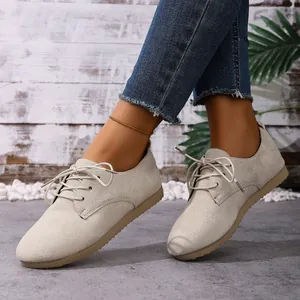 Detailed view of beige suede lace-up casual flats for women with high-quality textured upper