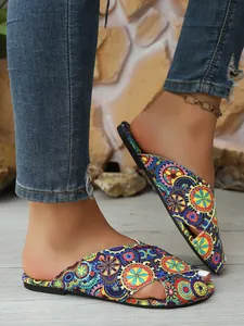 Detail view of women's ethnic floral print flat slides with bohemian style pattern
