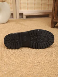 Detailed view of the anti-slip chunky rubber sole on women's fashion boots