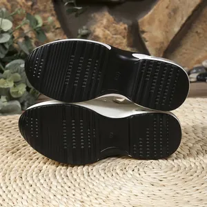 Detailed view of the durable anti-slip black rubber outsole on platform women's sandals