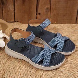 Comfortable navy blue women's sandals with woven straps and thick soles in detail