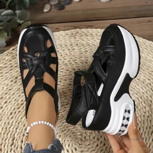Detailed view of black platform sandals featuring a woven toe and thick white wedge sole
