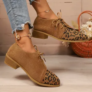 Detail shot of women's leopard print suede loafers featuring pointed toe and side lace-up