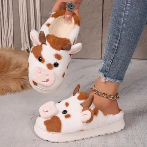 Close-up of cute cow plush slippers featuring thick anti-slip soles and soft faux fur texture.