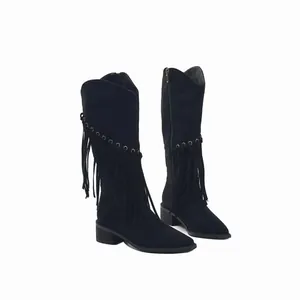 Detailed shot focusing on the suede texture and fringe accents of black knee-high boots