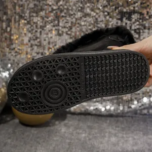 Close-up showing the durable anti-slip pattern of the rubber sole on a black winter snow boot.