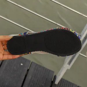 Detailed close-up of the durable black non-slip rubber sole on ethnic print sandals
