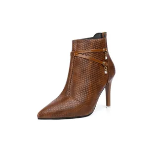 Detailed side view of brown pointed-toe stiletto ankle boots with rhinestone charms